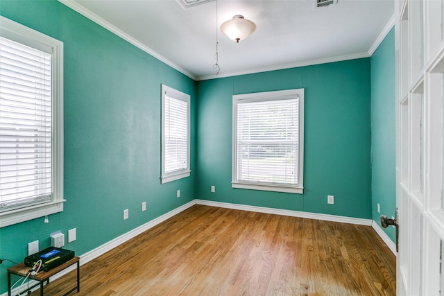 202 N St, Grand Prairie, TX 75050 - unfurnished room featuring plenty of natural light, wood finished floors, and crown molding