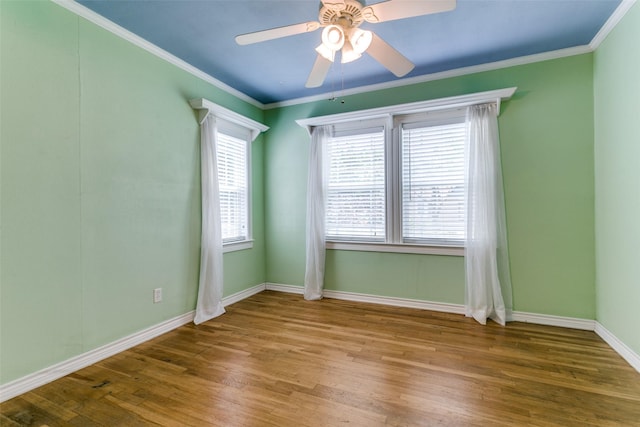 202 N St, Grand Prairie, TX 75050 - spare room featuring healthy amount of natural light, wood finished floors, ornamental molding, and a ceiling fan