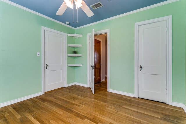 202 N St, Grand Prairie, TX 75050 - unfurnished bedroom featuring wood finished floors, ornamental molding, and a ceiling fan
