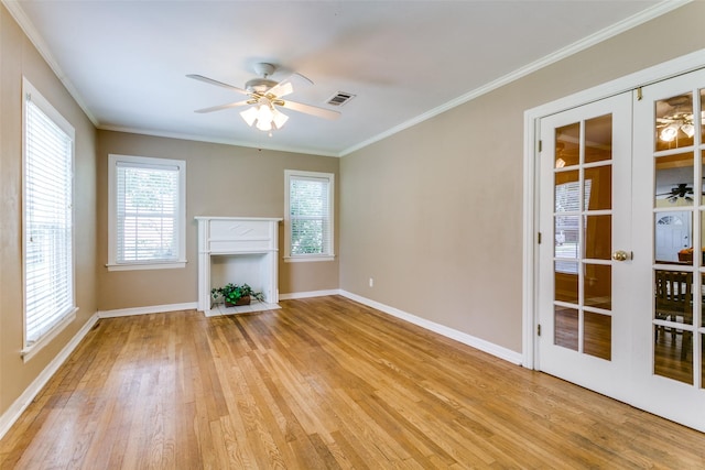202 N St, Grand Prairie, TX 75050 - unfurnished living room with a ceiling fan, light wood-style flooring, ornamental molding, and healthy amount of natural light