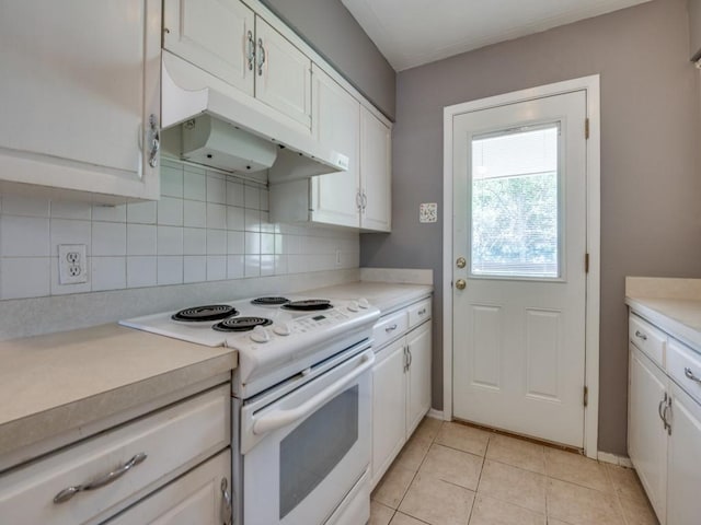2504 W Rochelle Rd, Irving, TX 75062 - kitchen with electric stove, under cabinet range hood, white cabinetry, and light countertops