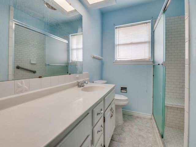 2504 W Rochelle Rd, Irving, TX 75062 - bathroom featuring toilet, a shower stall, vanity, a skylight, and baseboards