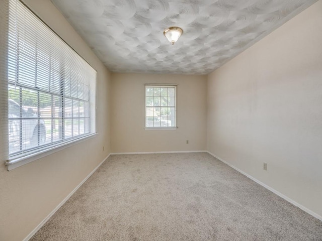 2504 W Rochelle Rd, Irving, TX 75062 - carpeted empty room featuring a textured ceiling and baseboards