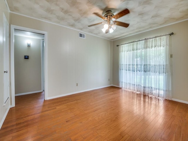 2504 W Rochelle Rd, Irving, TX 75062 - empty room featuring a ceiling fan, ornamental molding, wood finished floors, and baseboards