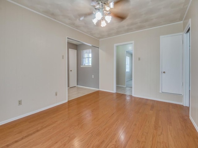 2504 W Rochelle Rd, Irving, TX 75062 - spare room featuring ceiling fan, light wood-style flooring, baseboards, and crown molding