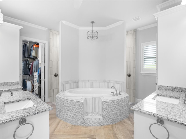 212 Nueces Trl, Aledo, TX 76008 - bathroom featuring vanity, a garden tub, ornamental molding, and a walk in closet
