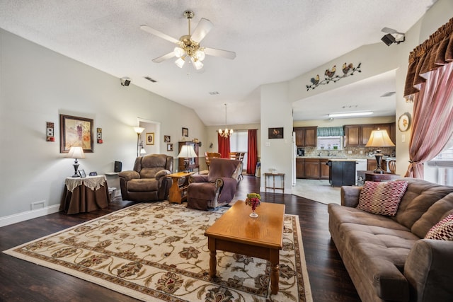 202 Yosemite Dr, Mansfield, TX 76063 - living room featuring a ceiling fan, vaulted ceiling, a chandelier, dark wood-style floors, and baseboards