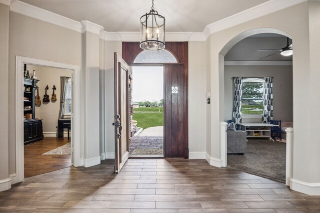 872 Hidden Pass, Royse City, TX 75189 - foyer featuring wood finished floors, arched walkways, crown molding, a ceiling fan, and a chandelier