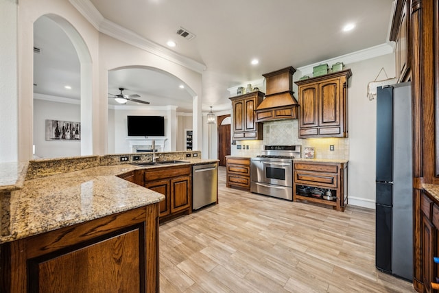 872 Hidden Pass, Royse City, TX 75189 - kitchen featuring appliances with stainless steel finishes, premium range hood, ceiling fan, crown molding, and backsplash