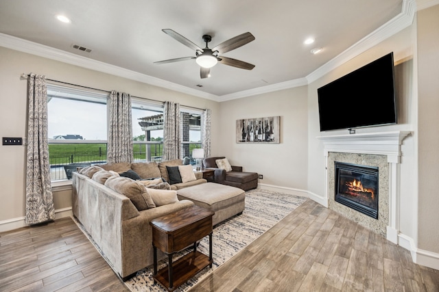 872 Hidden Pass, Royse City, TX 75189 - living area with wood finished floors, ceiling fan, a glass covered fireplace, healthy amount of natural light, and ornamental molding