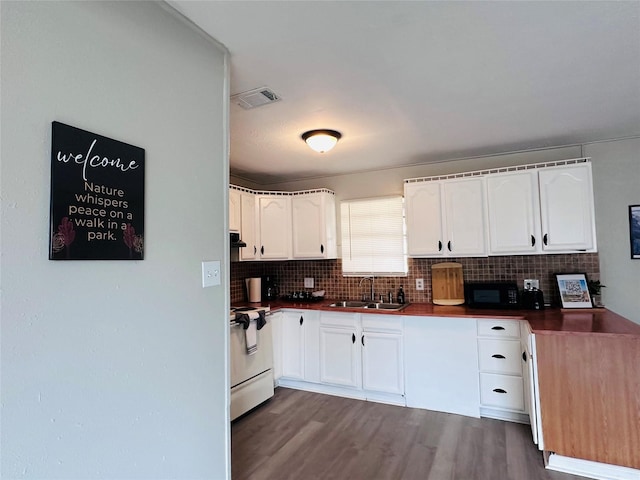 3007 Gaines St, Bossier City, LA 71111 - kitchen with a sink, black microwave, white electric range, decorative backsplash, and dark countertops