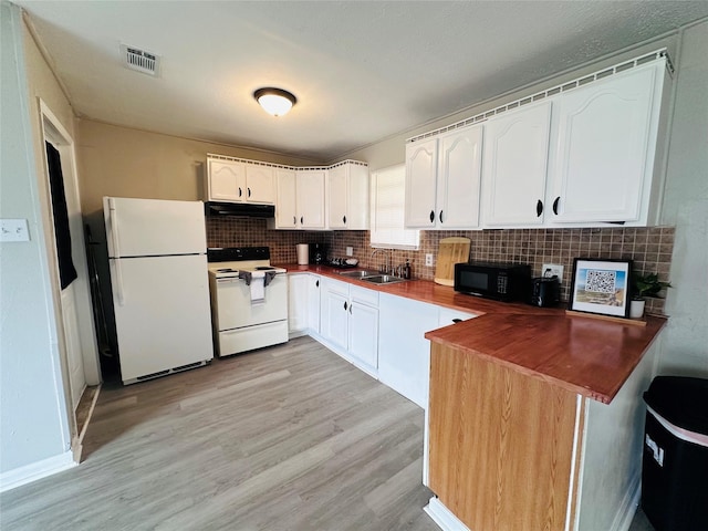 3007 Gaines St, Bossier City, LA 71111 - kitchen featuring white appliances, light wood-type flooring, backsplash, and white cabinets