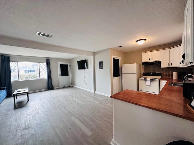 3007 Gaines St, Bossier City, LA 71111 - kitchen featuring white appliances, a sink, range hood, open floor plan, and light wood-style floors