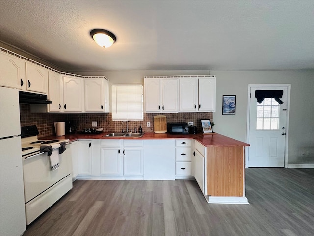 3007 Gaines St, Bossier City, LA 71111 - kitchen with white appliances, a sink, wood finished floors, extractor fan, and white cabinetry