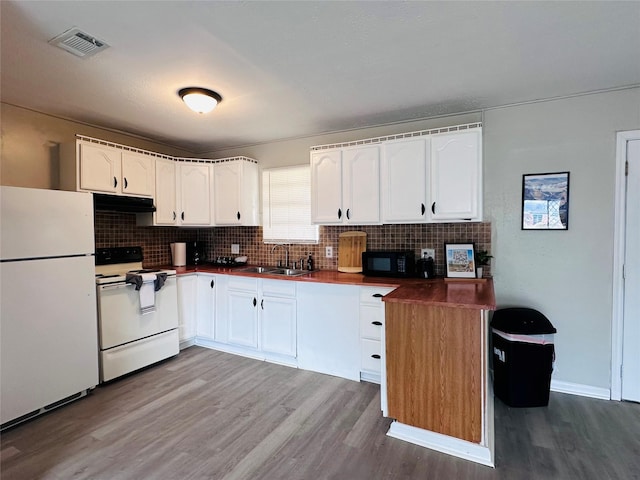 3007 Gaines St, Bossier City, LA 71111 - kitchen featuring white appliances, a sink, wood finished floors, tasteful backsplash, and white cabinets