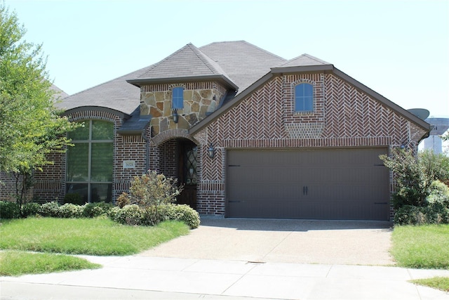 16324 Toledo Bend Ct, Prosper, TX 75078 - view of front of house featuring a garage, concrete driveway, brick siding, and stone siding