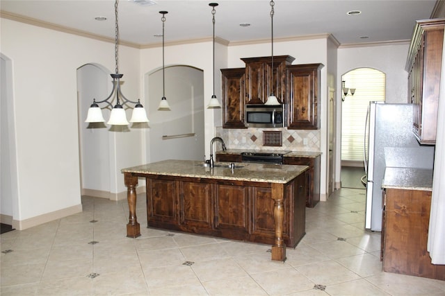 16324 Toledo Bend Ct, Prosper, TX 75078 - kitchen with appliances with stainless steel finishes, a sink, tasteful backsplash, light stone countertops, and arched walkways
