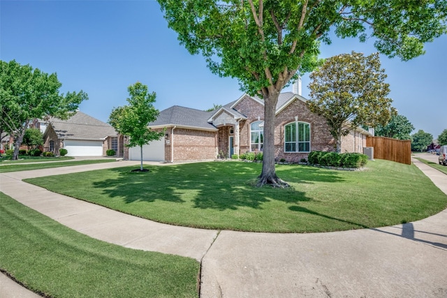1200 Stonehedge Pl, Flower Mound, TX 75028 - view of front facade featuring brick siding, an attached garage, a front lawn, and driveway
