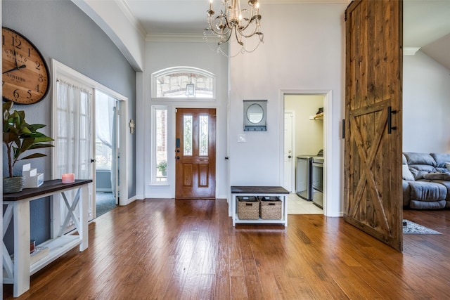 1200 Stonehedge Pl, Flower Mound, TX 75028 - foyer with wood-type flooring, a chandelier, a high ceiling, baseboards, and ornamental molding