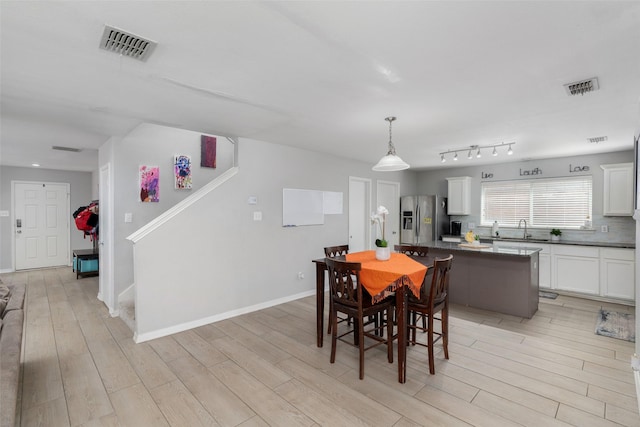 303 Highland Glen Dr, Wylie, TX 75098 - dining room featuring light wood-style floors, stairs, and baseboards