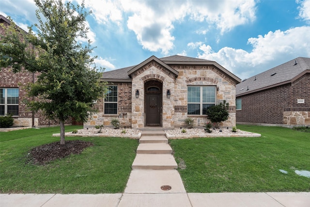 2705 Hancock Ln, Celina, TX 75009 - french country style house featuring a front yard and stone siding