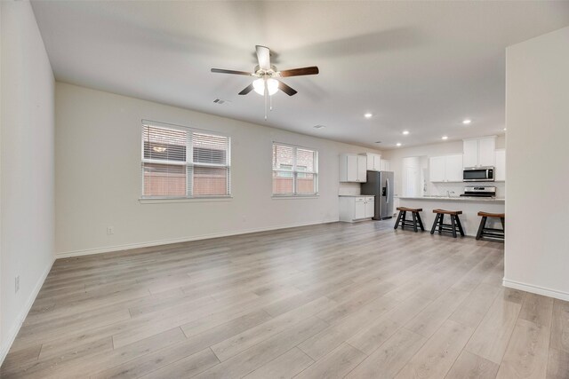 2705 Hancock Ln, Celina, TX 75009 - unfurnished living room with a ceiling fan, recessed lighting, light wood-style flooring, and baseboards