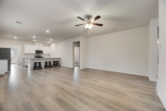 2705 Hancock Ln, Celina, TX 75009 - living area with ceiling fan, baseboards, recessed lighting, and light wood-type flooring
