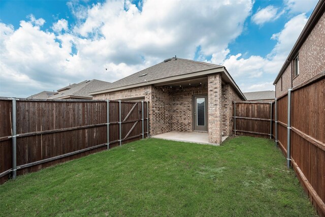 2705 Hancock Ln, Celina, TX 75009 - rear view of house featuring a patio area, brick siding, and roof with shingles