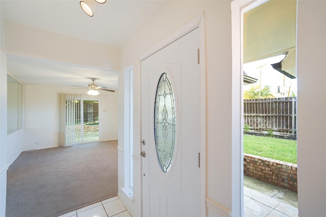 2825 Summit View Dr, Bedford, TX 76021 - foyer entrance featuring light carpet, healthy amount of natural light, light tile patterned flooring, and a ceiling fan
