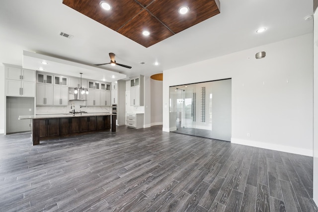2522 Hardwick Ln, Cedar Hill, TX 75104 - unfurnished living room featuring a ceiling fan, dark wood-type flooring, baseboards, a sink, and recessed lighting