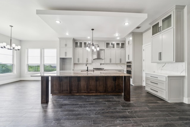 2522 Hardwick Ln, Cedar Hill, TX 75104 - kitchen featuring a chandelier, recessed lighting, dark wood-type flooring, wall chimney exhaust hood, and a sink