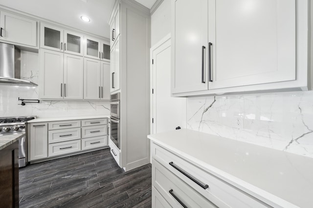 2522 Hardwick Ln, Cedar Hill, TX 75104 - kitchen featuring gas range, wall chimney range hood, backsplash, white cabinets, and glass insert cabinets