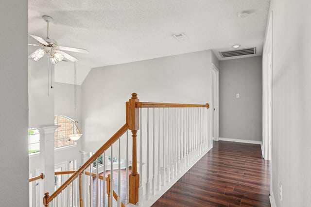 600 Harrison Hill Ct, Coppell, TX 75019 - hallway featuring an upstairs landing, wood finished floors, baseboards, vaulted ceiling, and a textured ceiling