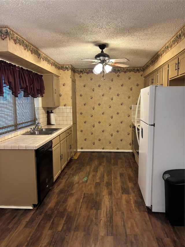 621 Lynnewood Ave, Burleson, TX 76028 - kitchen featuring freestanding refrigerator, dishwasher, tile counters, a sink, and a textured ceiling