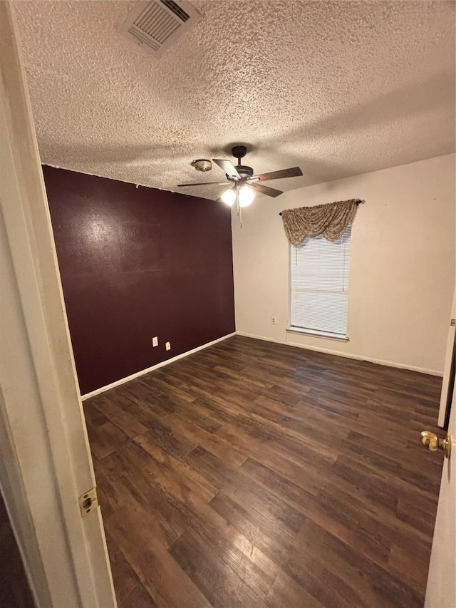 621 Lynnewood Ave, Burleson, TX 76028 - unfurnished room featuring dark wood-type flooring, ceiling fan, and a textured ceiling