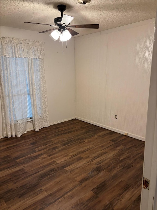 621 Lynnewood Ave, Burleson, TX 76028 - spare room featuring a textured ceiling, dark wood finished floors, ceiling fan, and baseboards