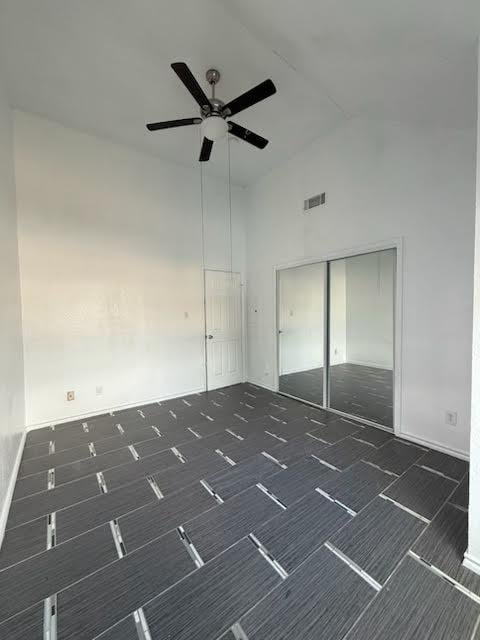 3404 W Country Club Dr Unit 264, Irving, TX 75038 - empty room with a ceiling fan and high vaulted ceiling