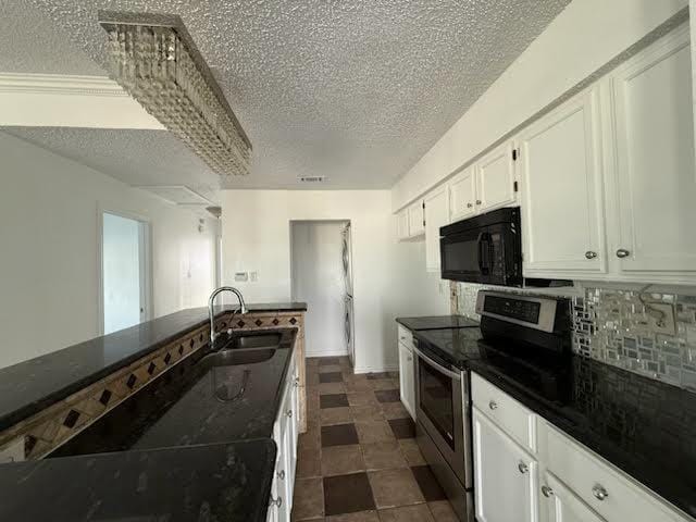 3404 W Country Club Dr Unit 264, Irving, TX 75038 - kitchen with stainless steel range with electric stovetop, black microwave, a textured ceiling, tasteful backsplash, and dark countertops