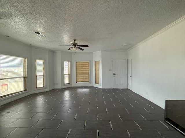 3404 W Country Club Dr Unit 264, Irving, TX 75038 - empty room featuring a ceiling fan, a textured ceiling, and crown molding
