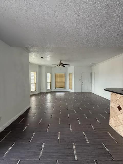 3404 W Country Club Dr Unit 264, Irving, TX 75038 - unfurnished living room featuring a textured ceiling and a ceiling fan
