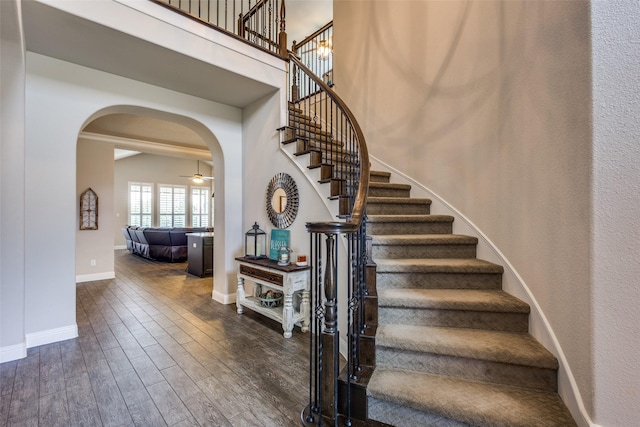 3900 Silent Water St, Mckinney, TX 75071 - stairway featuring arched walkways, wood finished floors, baseboards, and ceiling fan
