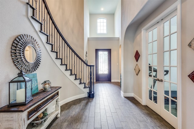 3900 Silent Water St, Mckinney, TX 75071 - entrance foyer featuring french doors, dark wood finished floors, baseboards, a high ceiling, and stairs