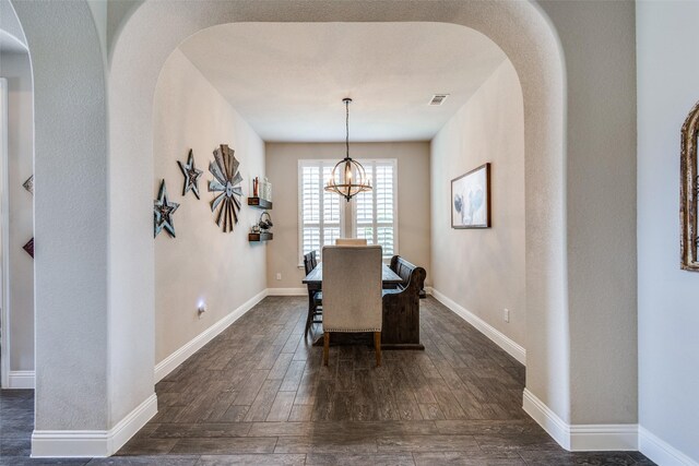 3900 Silent Water St, Mckinney, TX 75071 - dining room with arched walkways, dark wood-type flooring, a chandelier, and baseboards