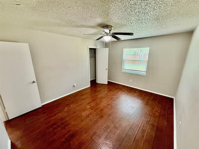517 Gristmill Ln, Everman, TX 76140 - unfurnished bedroom featuring wood finished floors, a textured ceiling, a closet, a ceiling fan, and baseboards