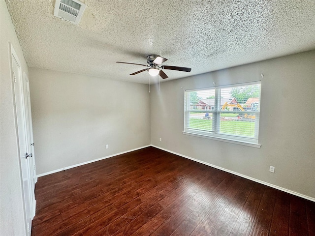 517 Gristmill Ln, Everman, TX 76140 - spare room with a ceiling fan, wood-type flooring, baseboards, and a textured ceiling