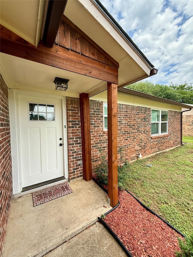 517 Gristmill Ln, Everman, TX 76140 - view of exterior entry with brick siding and a lawn