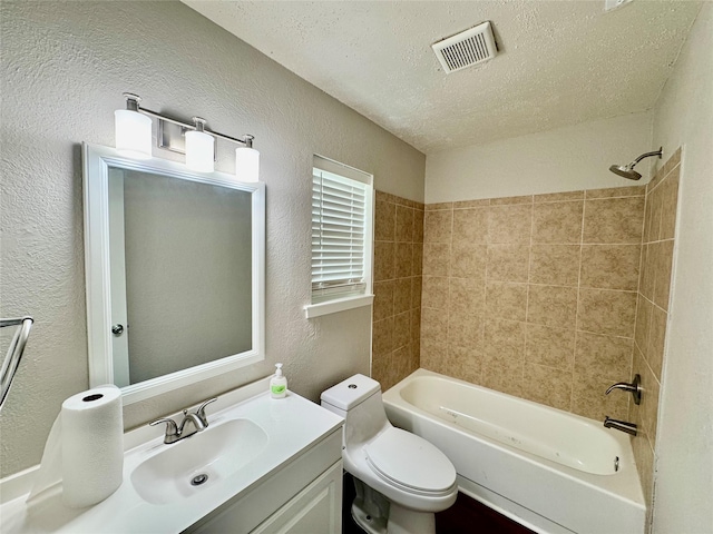 517 Gristmill Ln, Everman, TX 76140 - bathroom with a textured wall, vanity, toilet, a textured ceiling, and shower / bathtub combination