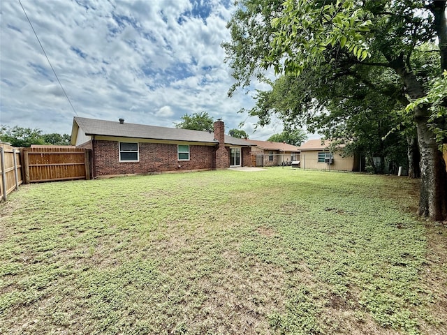 517 Gristmill Ln, Everman, TX 76140 - back of house featuring a chimney and brick siding