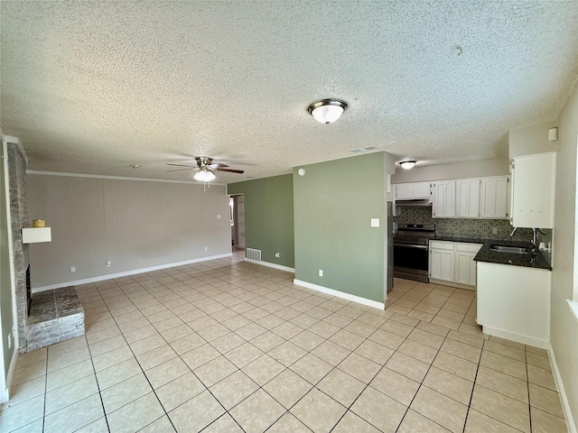 517 Gristmill Ln, Everman, TX 76140 - unfurnished living room with ceiling fan, light tile patterned floors, a sink, a textured ceiling, and baseboards