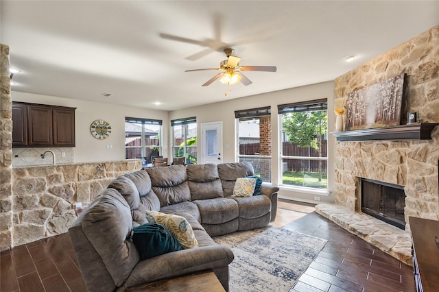 3028 Maple Creek Dr, Fort Worth, TX 76177 - living area with wood finished floors, ceiling fan, and a stone fireplace